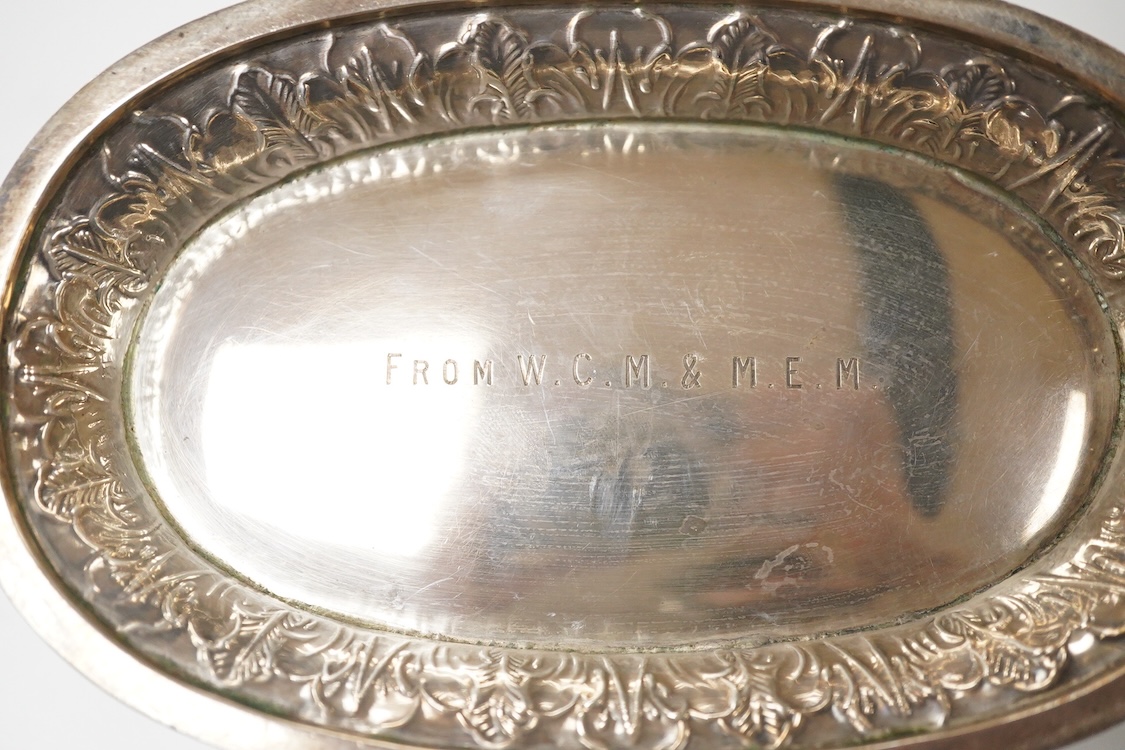 A late Victorian embossed silver oval bowl, by Charles Stuart Harris, with engraved initials to the base, London, 1890, length 16.4cm, 7.3oz.